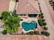 Aerial view of a serene backyard oasis including a kidney-shaped pool, patio, and desert landscaping at 22504 N San Ramon Dr, Sun City West, AZ 85375
