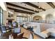 An elegant restaurant showcases a cozy fireplace, stylish booths, and warm lighting for a welcoming atmosphere at 22504 N San Ramon Dr, Sun City West, AZ 85375