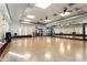 Spacious studio with hardwood floors, mirrored walls, and ceiling fans provides an ideal workout space at 22504 N San Ramon Dr, Sun City West, AZ 85375
