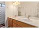 Bright bathroom featuring double sinks, white countertops, and framed mirror at 2327 E Edna Ave, Phoenix, AZ 85022