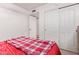 Bedroom with a plaid blanket on the bed and sliding-door closet at 2327 E Edna Ave, Phoenix, AZ 85022