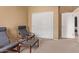 Relaxing bedroom featuring two relaxing chairs, ottoman and closet for storage at 2327 E Edna Ave, Phoenix, AZ 85022