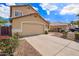 Tan single-Gathering home with a two-car garage and desert landscaping creating great curb appeal at 2327 E Edna Ave, Phoenix, AZ 85022