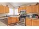 Well-equipped kitchen with stainless steel appliances, wood cabinetry, and a convenient layout for cooking at 2327 E Edna Ave, Phoenix, AZ 85022