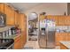 Kitchen with stainless steel refrigerator and ample cabinet space, open to other rooms at 2327 E Edna Ave, Phoenix, AZ 85022