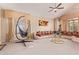 Spacious living room boasts vaulted ceilings, plush seating, and a unique hanging chair at 2327 E Edna Ave, Phoenix, AZ 85022
