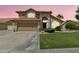 Charming two-story home featuring a well-maintained lawn and a two car attached garage at 2340 W Myrtle Dr, Chandler, AZ 85248
