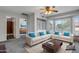 Comfortable living room with large windows, built-in shelving, and neutral-colored furniture at 2340 W Myrtle Dr, Chandler, AZ 85248