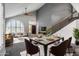 Inviting living room with vaulted ceilings, large arched window, dining area and staircase at 2340 W Myrtle Dr, Chandler, AZ 85248