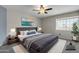 Inviting main bedroom with a plush bed, ceiling fan, and ample natural light from a large window at 2340 W Myrtle Dr, Chandler, AZ 85248