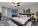 Serene main bedroom featuring a ceiling fan, modern furnishings and an attached bathroom at 2340 W Myrtle Dr, Chandler, AZ 85248