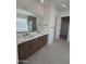 Elegant bathroom with double sinks, marble countertops, and a soaking tub with natural light at 24088 S 218Th Pl, Queen Creek, AZ 85142
