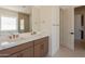 Bathroom featuring double sinks with quartz counters and a glass-enclosed shower at 24088 S 218Th Pl, Queen Creek, AZ 85142