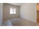 Bedroom with window, neutral carpet, and fresh, white paint at 24088 S 218Th Pl, Queen Creek, AZ 85142