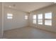 Bright, empty bedroom with multiple windows and tiled floors at 24088 S 218Th Pl, Queen Creek, AZ 85142