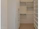 Walk-in closet with custom shelving, drawers, and hanging rods for optimal organization at 24088 S 218Th Pl, Queen Creek, AZ 85142
