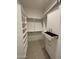 Spacious walk-in closet with custom shelving, rods, and storage compartments for ample organization at 24088 S 218Th Pl, Queen Creek, AZ 85142