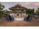 Community outdoor space with a covered gazebo with a fire pit, chairs, and tables, perfect for gathering with friends at 24088 S 218Th Pl, Queen Creek, AZ 85142