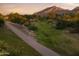 Scenic community path with lush greenery and view of the majestic mountain in the distance at 24088 S 218Th Pl, Queen Creek, AZ 85142