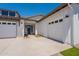 Spacious driveway and three-car garage enhance this stylish single-Gathering home's curb appeal at 24088 S 218Th Pl, Queen Creek, AZ 85142