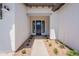 Welcoming entrance with a modern dark-blue front door and manicured landscaping at 24088 S 218Th Pl, Queen Creek, AZ 85142