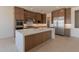Gourmet kitchen with an island, stainless steel appliances, custom cabinets, and ample counter space at 24088 S 218Th Pl, Queen Creek, AZ 85142