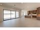 Spacious living room featuring sliding glass doors and an open floor plan flowing into the modern kitchen at 24088 S 218Th Pl, Queen Creek, AZ 85142