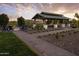 Inviting outdoor gathering space featuring a covered pergola, fire pit, and ample seating at sunset at 24088 S 218Th Pl, Queen Creek, AZ 85142