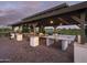 Covered outdoor area with barbecue grills, tables, ping pong, seating and manicured landscaping at 24088 S 218Th Pl, Queen Creek, AZ 85142
