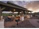 Spacious covered outdoor gathering space with mountain views, grill, table and seating at 24088 S 218Th Pl, Queen Creek, AZ 85142
