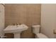 Stylish powder room with hexagon tile wall accent, white sink, and toilet at 24088 S 218Th Pl, Queen Creek, AZ 85142
