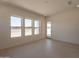 Empty room featuring multiple windows and tiled floors at 24088 S 218Th Pl, Queen Creek, AZ 85142