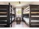 Shared bedroom featuring two bunk beds, a center table, and wood-look floors for a rustic design at 2430 E Hermosa Dr, Tempe, AZ 85282