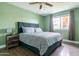 Comfortable bedroom with a ceiling fan, warm green walls, and wood-look floors for a natural feel at 2430 E Hermosa Dr, Tempe, AZ 85282