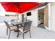 Covered patio with dining set, outdoor TV, and access to the kitchen and backyard at 2430 E Hermosa Dr, Tempe, AZ 85282