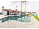 Backyard with a large swimming pool, patio area with dining set, and desert landscaping at 2430 E Hermosa Dr, Tempe, AZ 85282