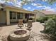 Beautiful backyard patio with seating area, fire pit, lush landscaping, and fountain for outdoor enjoyment at 27158 W Potter Dr, Buckeye, AZ 85396