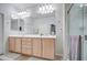 Well-lit bathroom with a double vanity and a large mirror at 27158 W Potter Dr, Buckeye, AZ 85396