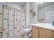 Cozy bathroom with butterfly themed shower curtain at 27158 W Potter Dr, Buckeye, AZ 85396