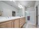 Bright bathroom featuring a double vanity and a glass-enclosed shower at 27158 W Potter Dr, Buckeye, AZ 85396