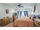 Bright bedroom with ceiling fan, wood-look flooring, and a bay window at 27158 W Potter Dr, Buckeye, AZ 85396