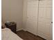 Bedroom with hardwood floors, closet with sliding doors, and wicker accents at 27158 W Potter Dr, Buckeye, AZ 85396