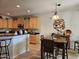 Open dining area features a modern light fixture and is adjacent to the kitchen at 27158 W Potter Dr, Buckeye, AZ 85396