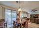 Bright dining area with sliding glass doors and a view into the adjacent living room at 27158 W Potter Dr, Buckeye, AZ 85396