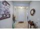 Elegant entryway with neutral walls, decorative artwork, and tile flooring at 27158 W Potter Dr, Buckeye, AZ 85396