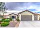 Charming single-story home with a well-maintained front yard and attached two-car garage at 27158 W Potter Dr, Buckeye, AZ 85396