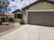 Inviting single-story home featuring a well-maintained yard, and two-car garage at 27158 W Potter Dr, Buckeye, AZ 85396
