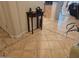 Elegant foyer with tile flooring, a decorative table, and a view into the living area at 27158 W Potter Dr, Buckeye, AZ 85396