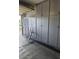 Organized garage with ample storage cabinets, a ladder, and durable flooring perfect for storage at 27158 W Potter Dr, Buckeye, AZ 85396
