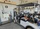 Functional garage featuring a golf cart, sink, shelving, and ample space perfect for hobbies at 27158 W Potter Dr, Buckeye, AZ 85396